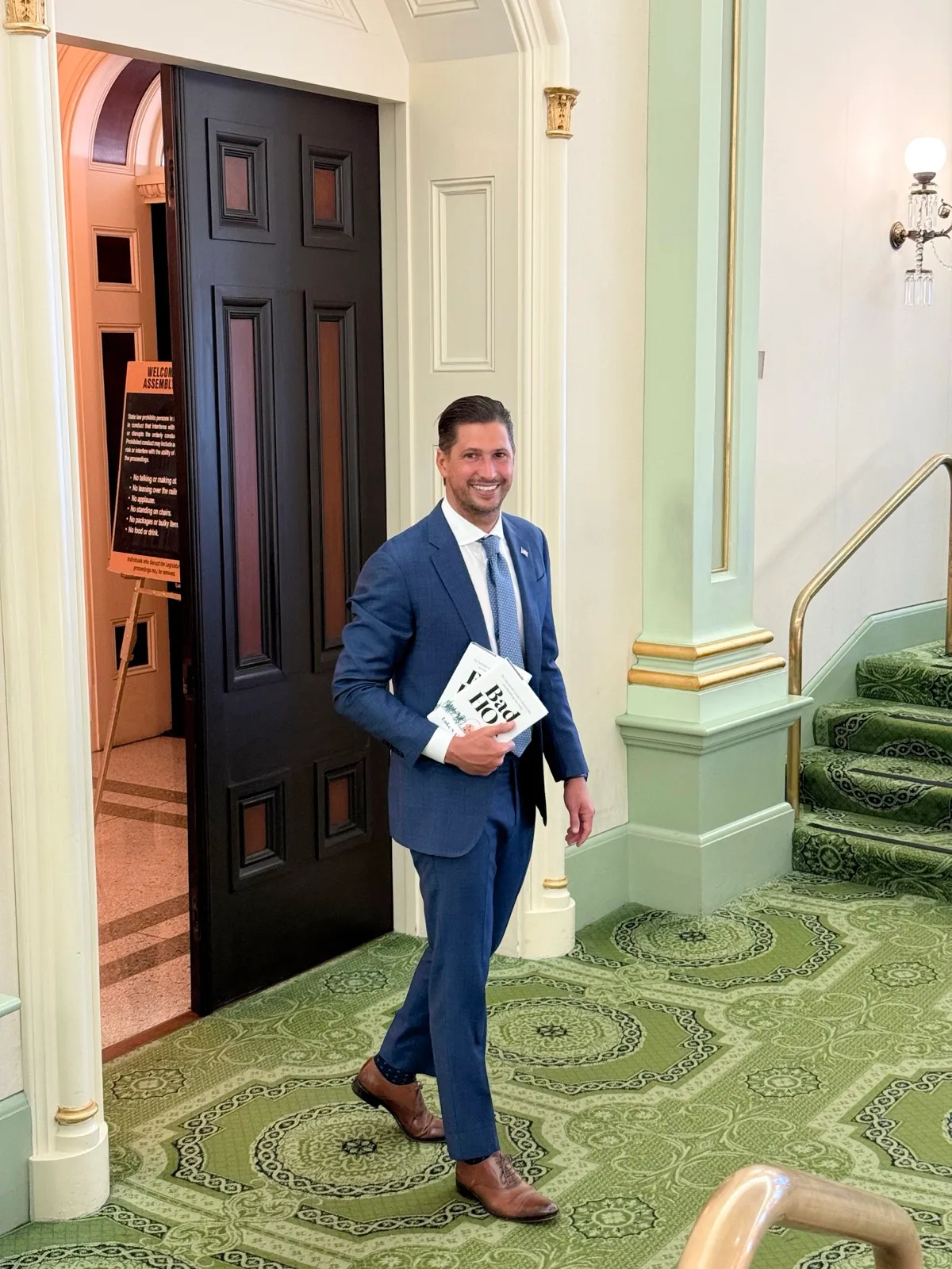 Luke S. Carlson, Esq. at the California State Capitol with copies of Bad HOA™